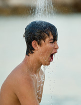 Boy taking cold water shower