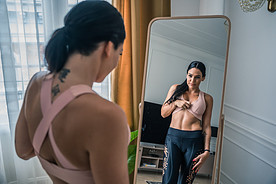 woman looking at mirror